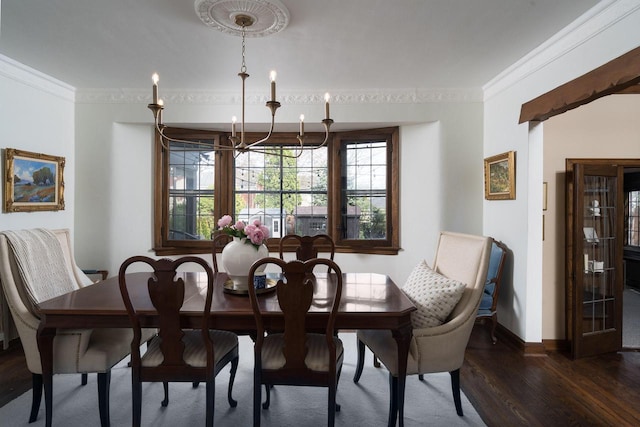 dining room with baseboards, a chandelier, dark wood-style floors, and ornamental molding