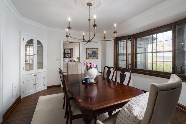dining room featuring baseboards, ornamental molding, dark wood-style floors, and a chandelier