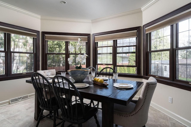 dining space with crown molding, baseboards, visible vents, and tile patterned floors