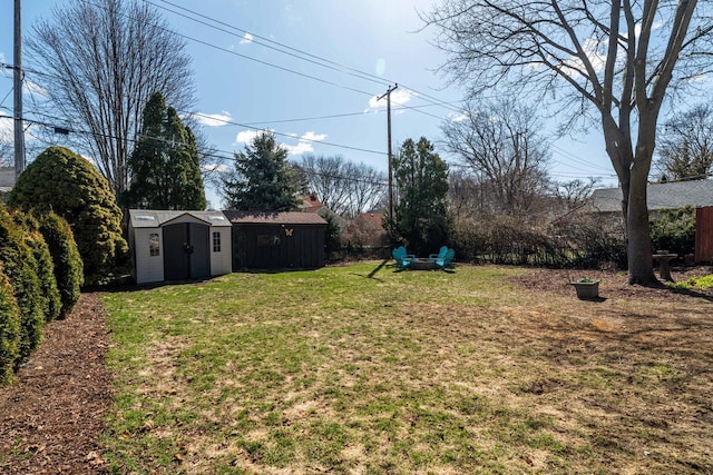 view of yard featuring a storage shed and an outbuilding