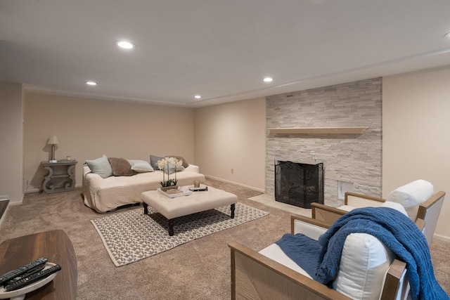 living area featuring carpet floors, recessed lighting, and a stone fireplace