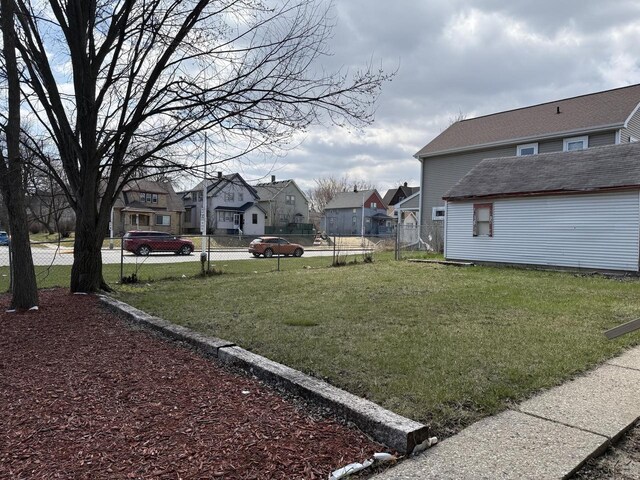 4813 N 36th St, Milwaukee, WI 53209 - view of yard featuring an outbuilding, fence, and a residential view
