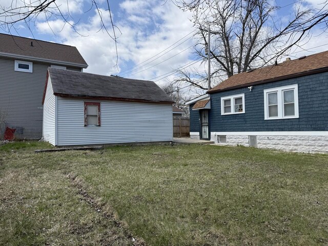4813 N 36th St, Milwaukee, WI 53209 - back of house featuring a yard, an outdoor structure, and a shingled roof