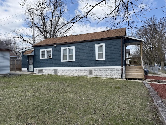 4813 N 36th St, Milwaukee, WI 53209 - view of side of property with fence, a lawn, and roof with shingles