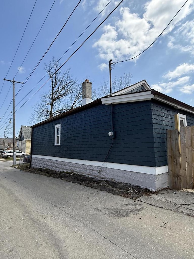 4813 N 36th St, Milwaukee, WI 53209 - view of property exterior with fence and a chimney