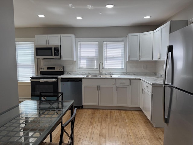 4813 N 36th St, Milwaukee, WI 53209 - kitchen featuring stainless steel appliances, decorative backsplash, and a healthy amount of sunlight