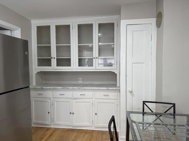 4813 N 36th St, Milwaukee, WI 53209 - kitchen with white cabinetry, freestanding refrigerator, and glass insert cabinets