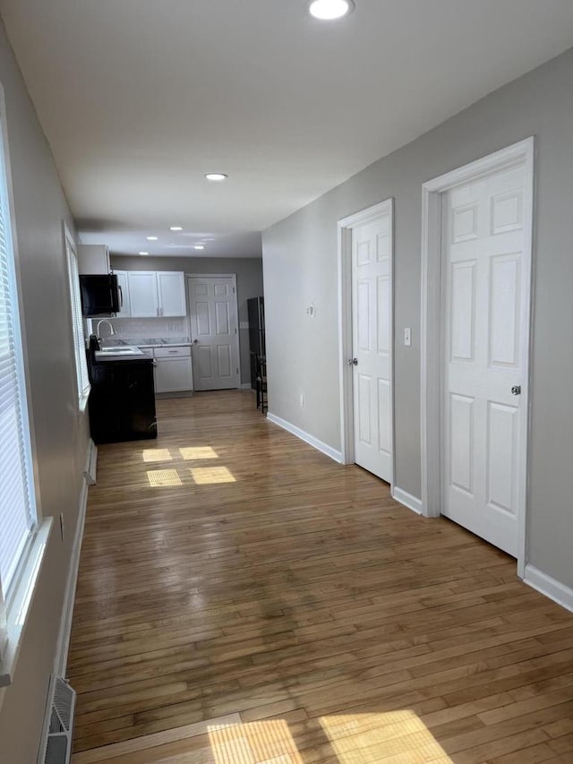4813 N 36th St, Milwaukee, WI 53209 - unfurnished living room featuring dark wood-style flooring, a sink, baseboards, and recessed lighting