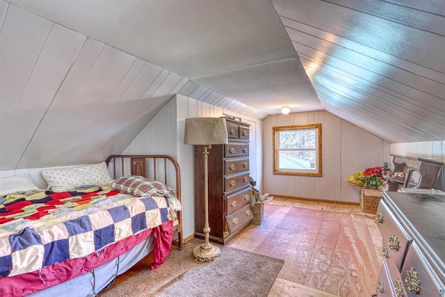 10439 W County Highway D, Exeland, WI 54835 - bedroom with wooden walls, baseboards, vaulted ceiling, and wood finished floors