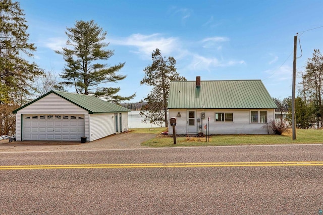 10439 W County Highway D, Exeland, WI 54835 - view of front of home with an outbuilding, metal roof, a front yard, a chimney, and a garage