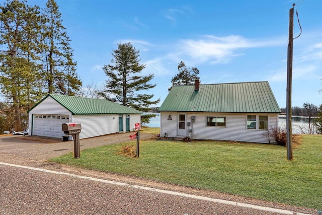 10439 W County Highway D, Exeland, WI 54835 - view of front of home with a front lawn, an outdoor structure, metal roof, and a garage