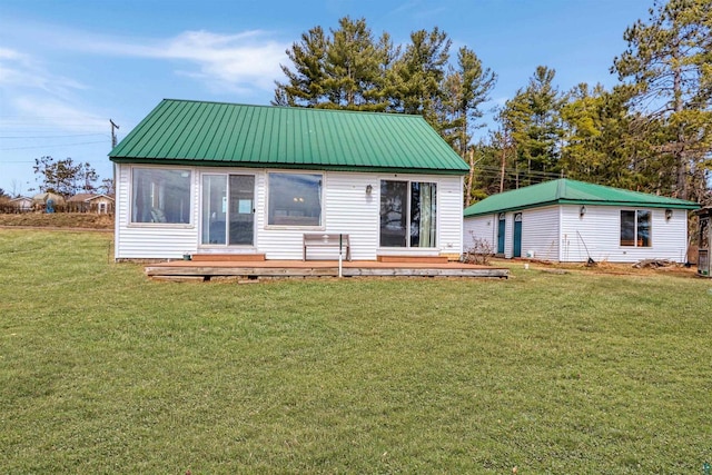 10439 W County Highway D, Exeland, WI 54835 - back of property with a yard, a deck, and metal roof