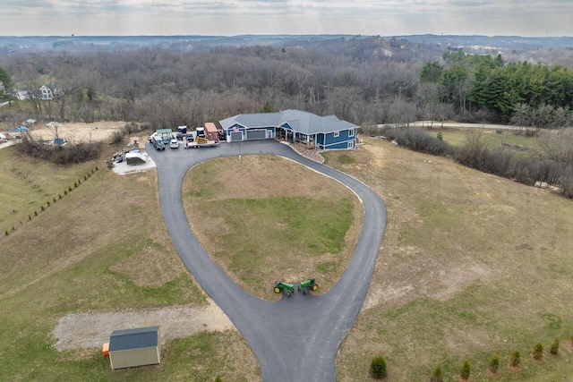 aerial view featuring a wooded view