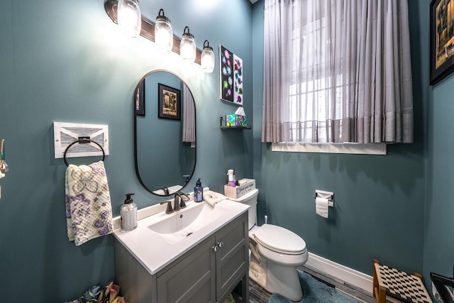 bathroom with toilet and vanity