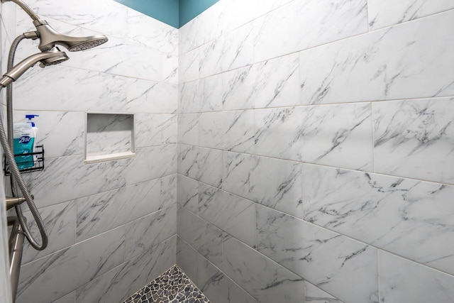 full bath featuring a tile shower
