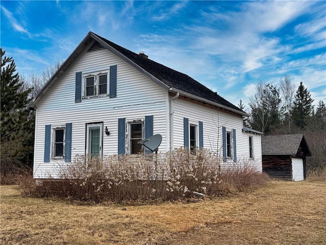 3168 W Howard St, Winter, WI 54896 - view of home's exterior with an outdoor structure and a lawn