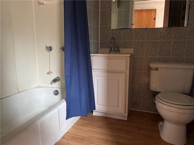 3168 W Howard St, Winter, WI 54896 - bathroom with tile walls, toilet, shower / bath combo with shower curtain, vanity, and wood finished floors