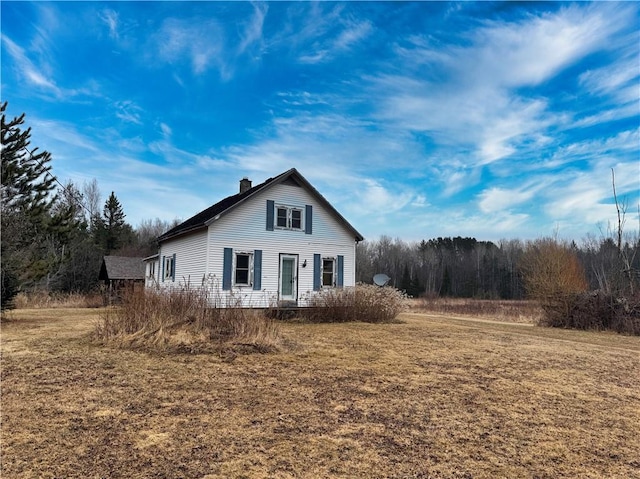 3168 W Howard St, Winter, WI 54896 - view of front of house with a chimney and a front lawn