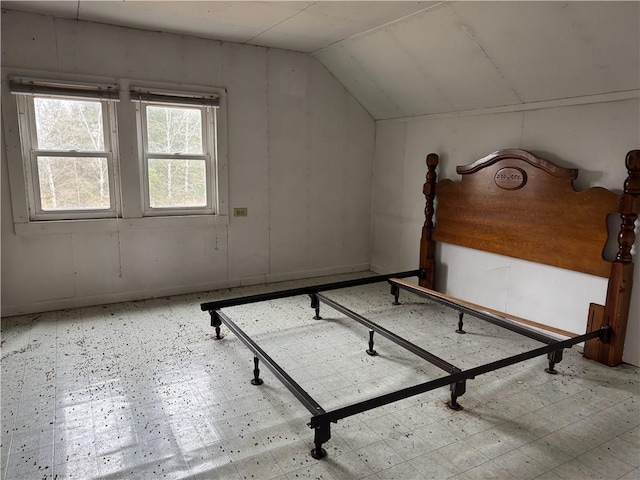 3168 W Howard St, Winter, WI 54896 - unfurnished bedroom featuring tile patterned floors and vaulted ceiling