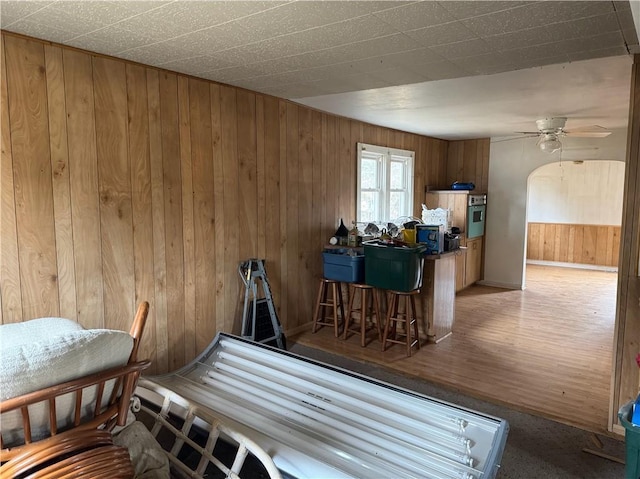 3168 W Howard St, Winter, WI 54896 - interior space with wood walls, baseboards, a ceiling fan, and wood finished floors