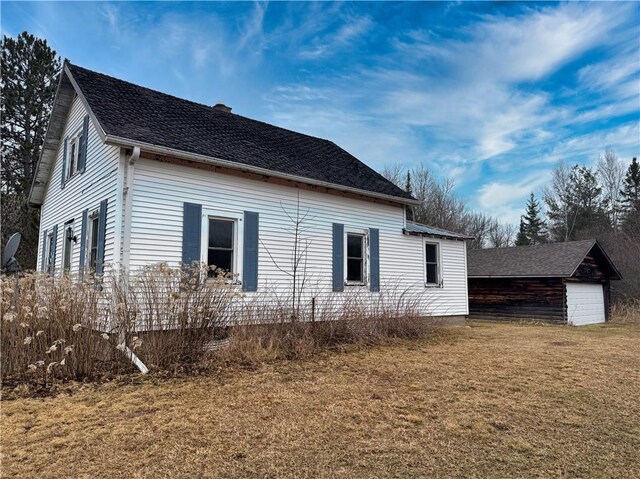 3168 W Howard St, Winter, WI 54896 - view of side of property featuring an outbuilding, a yard, and a chimney