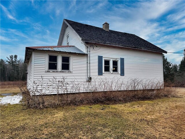 3168 W Howard St, Winter, WI 54896 - view of side of home featuring a yard and a chimney