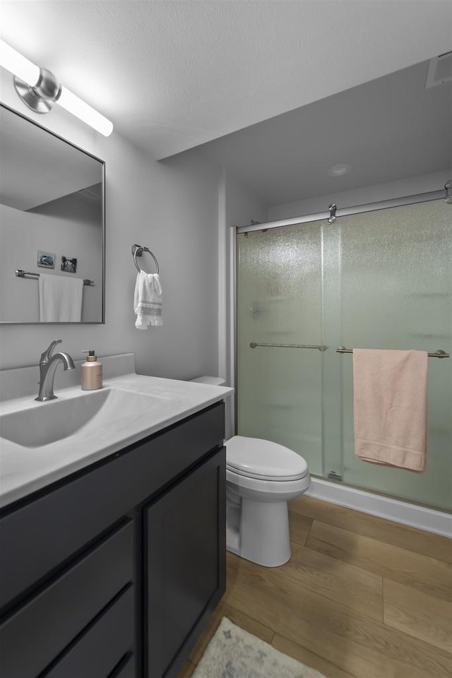 3247 Prospect Dr, Sun Prairie, WI 53590 - full bath with a stall shower, toilet, wood finished floors, and vanity