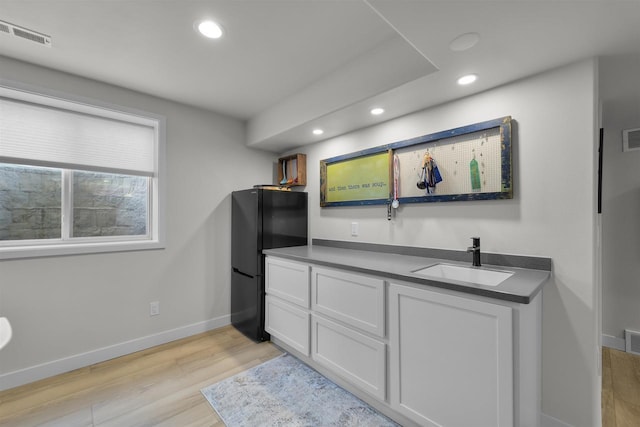 3247 Prospect Dr, Sun Prairie, WI 53590 - kitchen with recessed lighting, freestanding refrigerator, light wood finished floors, a sink, and visible vents