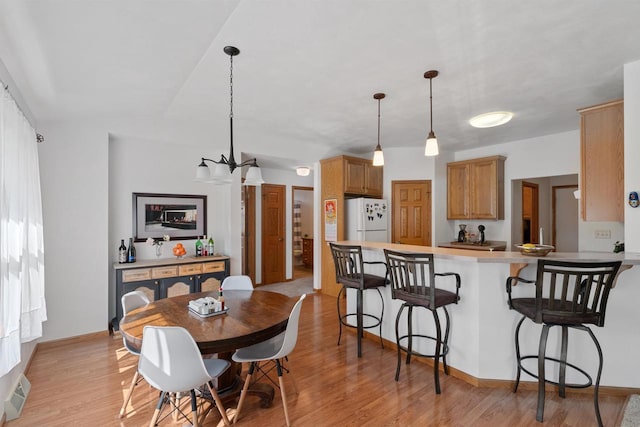 621 Voyagers Trl, Berlin, WI 54923 - dining space with visible vents, light wood-style flooring, a chandelier, and baseboards