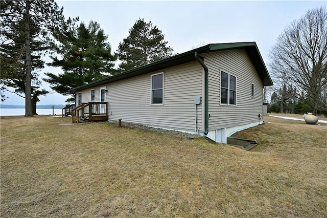view of property exterior with a water view and a yard