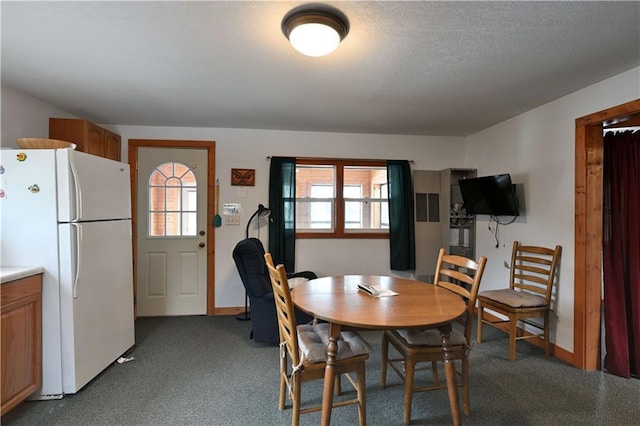 dining room featuring dark carpet and a healthy amount of sunlight