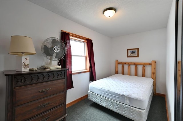 carpeted bedroom featuring baseboards