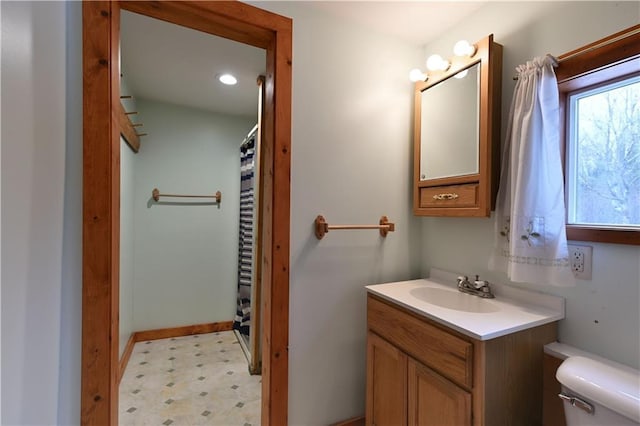 bathroom with tile patterned floors, toilet, curtained shower, and vanity