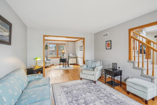 7817 Brule St, Madison, WI 53717 - living room featuring visible vents, baseboards, stairway, and wood finished floors