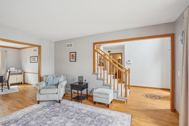 7817 Brule St, Madison, WI 53717 - living area featuring visible vents, baseboards, stairway, and wood finished floors