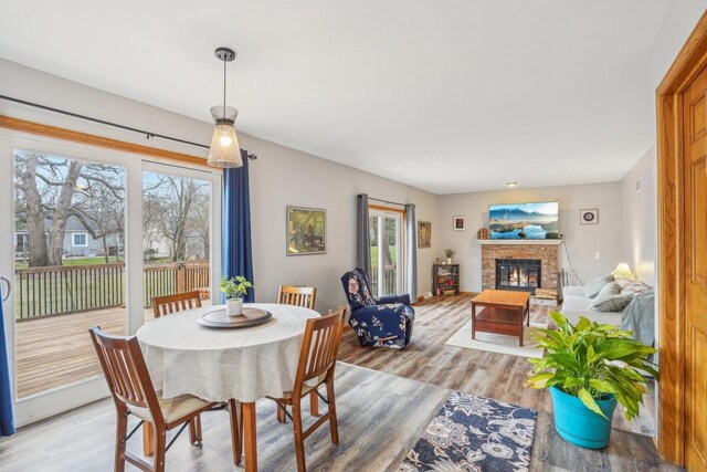 7817 Brule St, Madison, WI 53717 - dining space with a fireplace, light wood-style floors, and baseboards