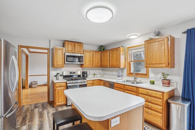 7817 Brule St, Madison, WI 53717 - kitchen featuring light countertops, wood finished floors, a sink, and stainless steel appliances