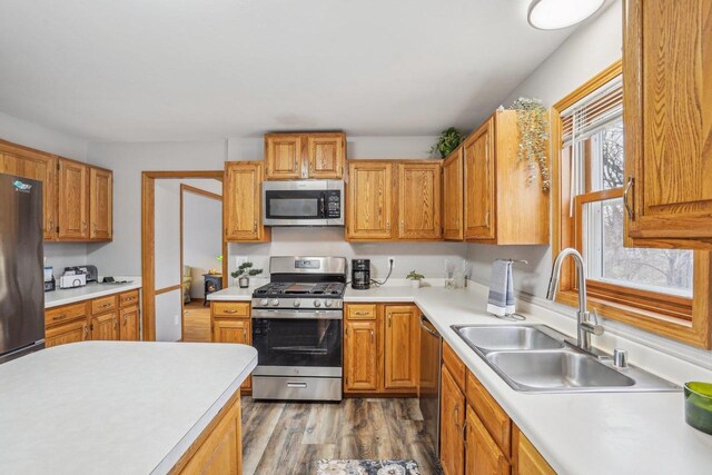 7817 Brule St, Madison, WI 53717 - kitchen featuring a sink, light countertops, appliances with stainless steel finishes, and wood finished floors