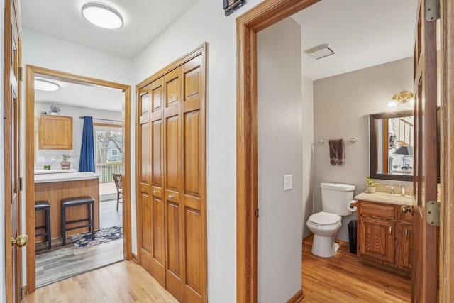7817 Brule St, Madison, WI 53717 - bathroom featuring toilet, wood finished floors, and vanity