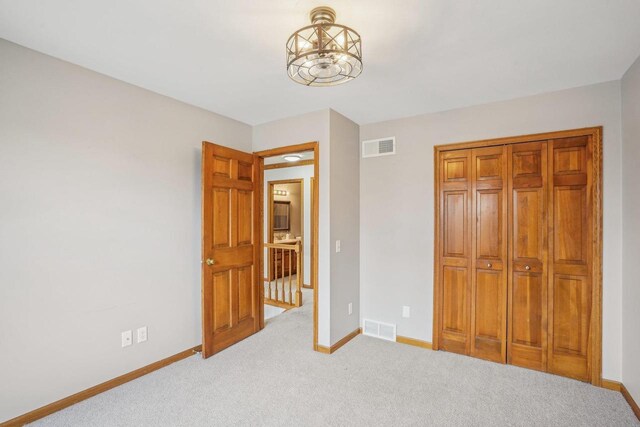 7817 Brule St, Madison, WI 53717 - unfurnished bedroom featuring carpet flooring, visible vents, baseboards, and an inviting chandelier