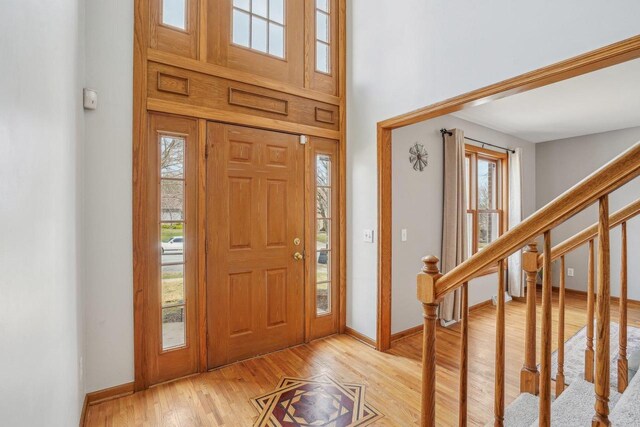 7817 Brule St, Madison, WI 53717 - entrance foyer featuring a wealth of natural light, stairs, light wood-type flooring, and baseboards
