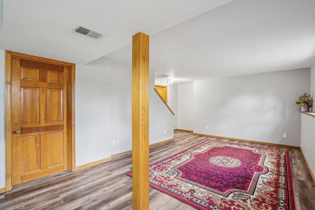 7817 Brule St, Madison, WI 53717 - finished basement with stairway, visible vents, baseboards, and wood finished floors