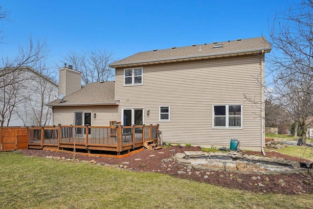 7817 Brule St, Madison, WI 53717 - back of property featuring a yard, fence, a chimney, a shingled roof, and a deck