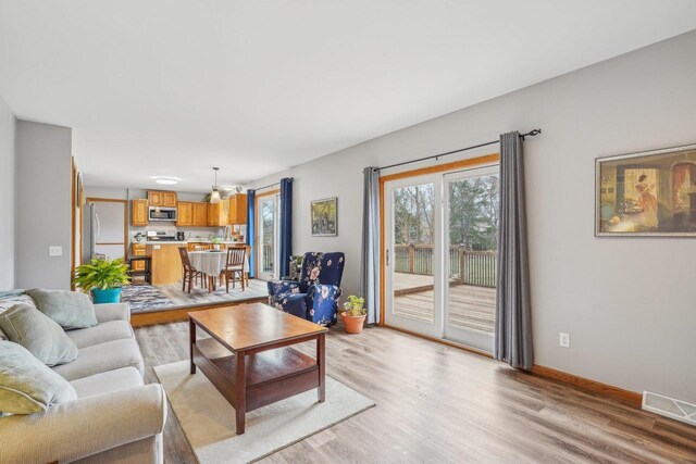 7817 Brule St, Madison, WI 53717 - living area featuring light wood-style floors, visible vents, and baseboards