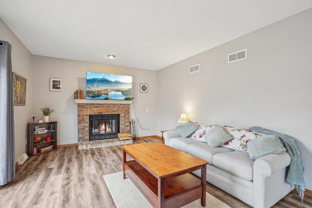 7817 Brule St, Madison, WI 53717 - living area featuring wood finished floors, a fireplace, baseboards, and visible vents