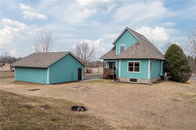 318 Meadow Lark Ln, Osceola, WI 54020 - rear view of property with cooling unit, roof with shingles, and an outdoor structure