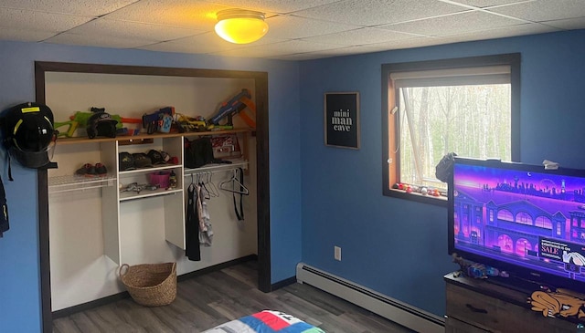 27200 N Maple Hill Rd, Washburn, WI 54891 - bedroom featuring a closet, a paneled ceiling, wood finished floors, and baseboard heating