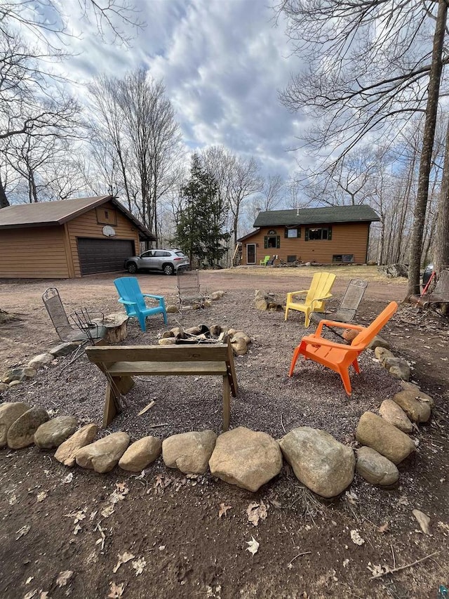 27200 N Maple Hill Rd, Washburn, WI 54891 - view of yard with a garage, an outbuilding, and an outdoor fire pit