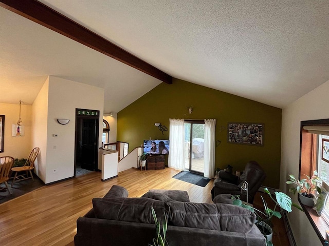 27200 N Maple Hill Rd, Washburn, WI 54891 - living area with a textured ceiling, wood finished floors, and vaulted ceiling with beams