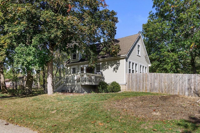 W3780 Cypress Dr, Lake Geneva, WI 53147 - view of front of property featuring a front yard, stairs, a deck, fence, and a shingled roof